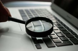 Magnifying glass, signifying the reporting features with doordash gift cards