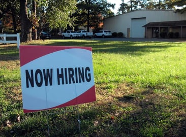 Now hiring sign to signify one of the effects of employee turnover
