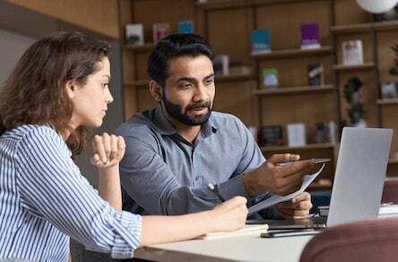 Indian teacher or mentor helping Latin student