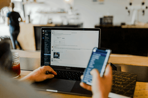 employee with phone and laptop