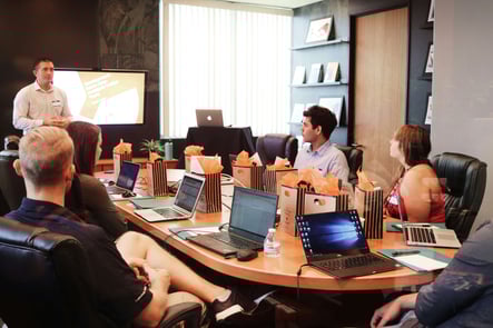 main presenting in an office in front of an audience